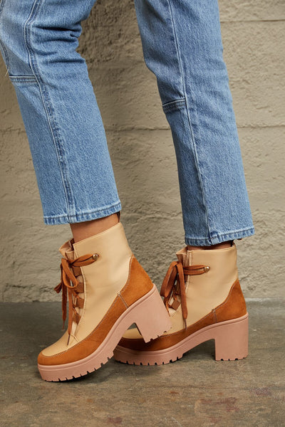Tan and brown faux leather block heel booties with laces.