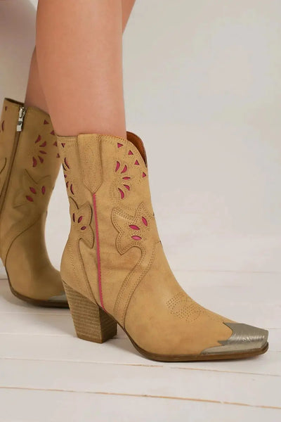 Beige cowboy boots with floral cut-outs, pink accents, and a silver toe cap.