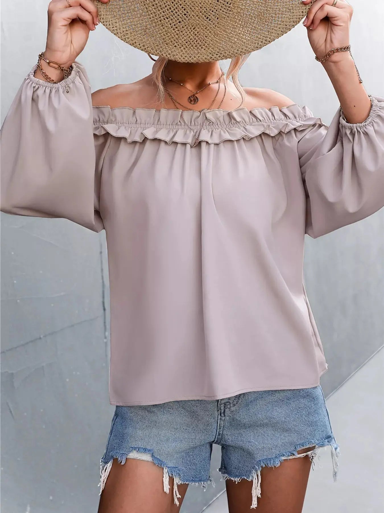 Trendsi off-shoulder long sleeve blouse with ruffled neckline and denim shorts.