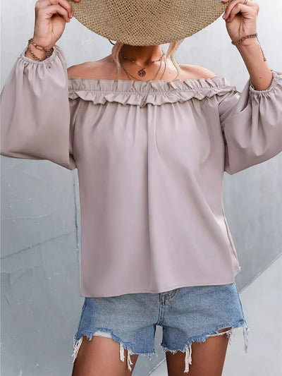 Trendsi off-shoulder long sleeve blouse with ruffled neckline and denim shorts.