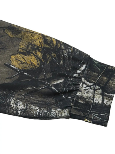 Asymmetrical long sleeve top with a camouflage print.