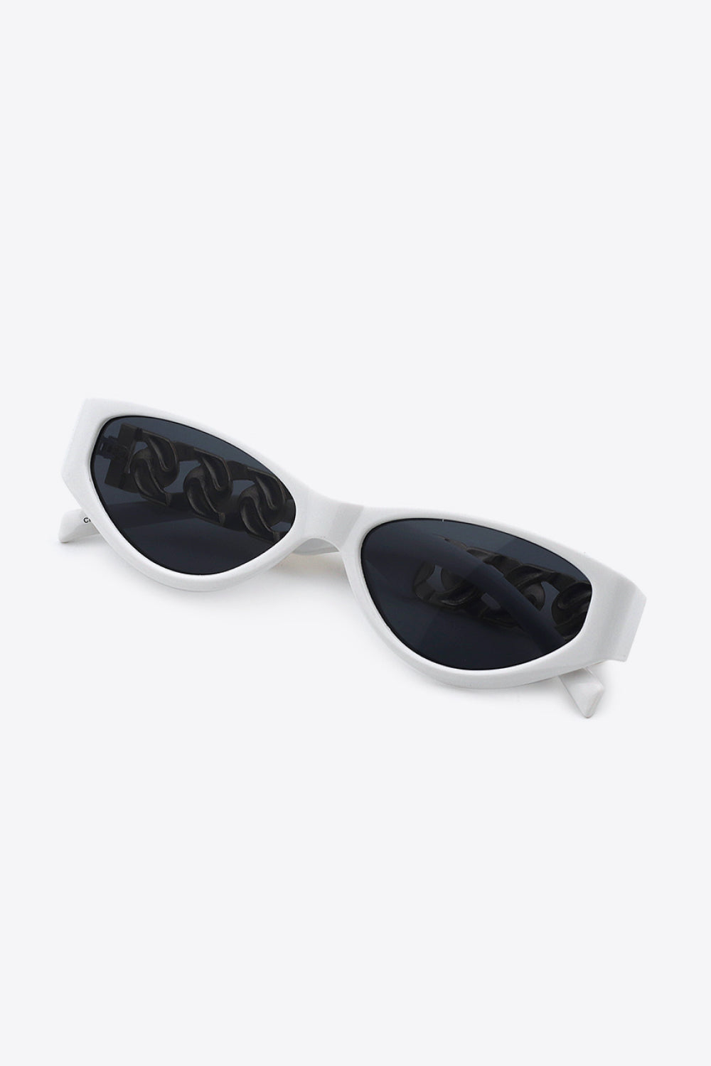 White cat eye sunglasses with a chain detail reflected in the dark lenses.