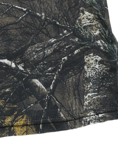 Asymmetrical long sleeve top with a camouflage print.