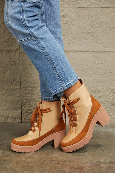 Tan and brown faux leather lace-up booties with block heels.