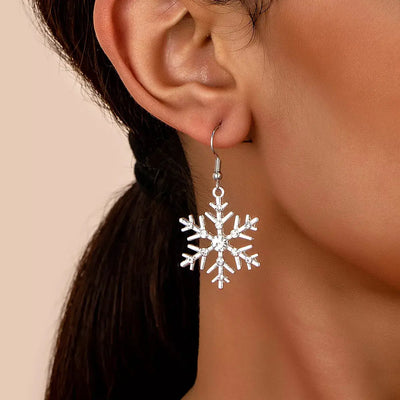 Silver-plated snowflake dangle earrings with rhinestones.