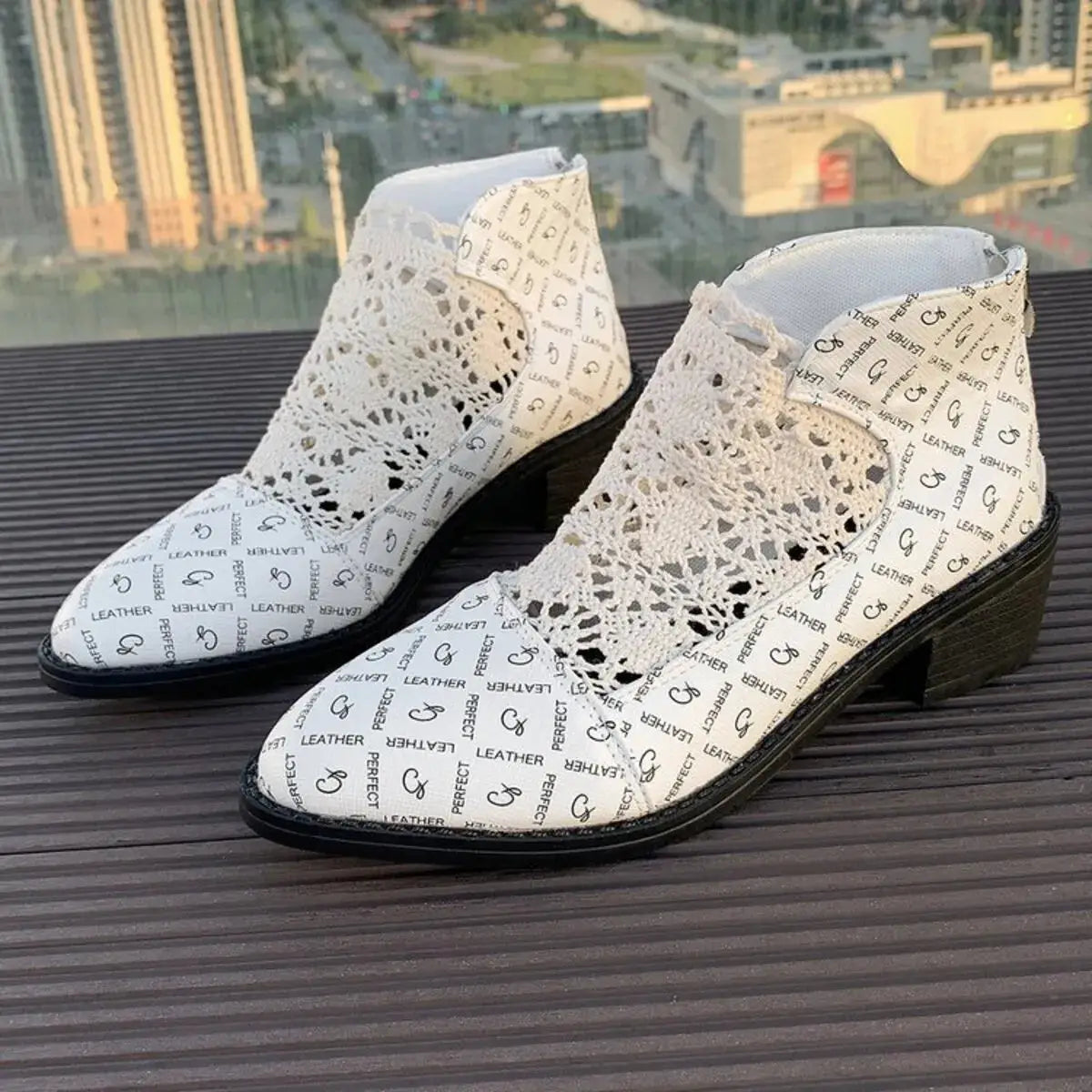 White mesh and printed PU leather low heel boots with a pointed toe.