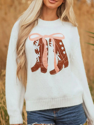 White drop shoulder sweater with embroidered cowboy boots and pink bow detail.
