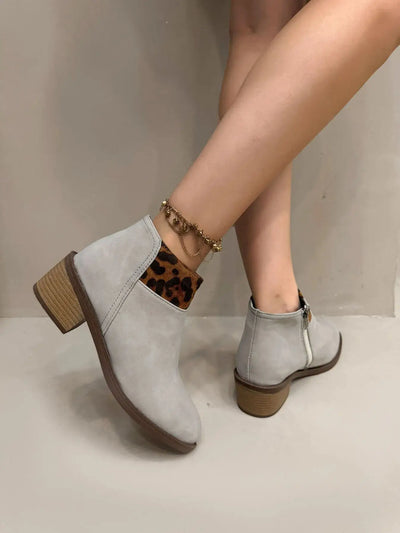 Light gray suede ankle boots with leopard print accents and a block heel.
