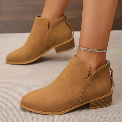 Brown PU leather pointed toe block heel booties with a zipper closure.