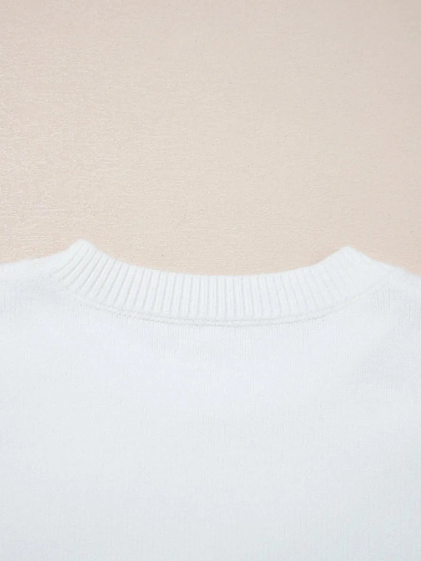 White knit sweater with ribbed crew neck.