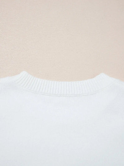 White knit sweater with ribbed crew neck.