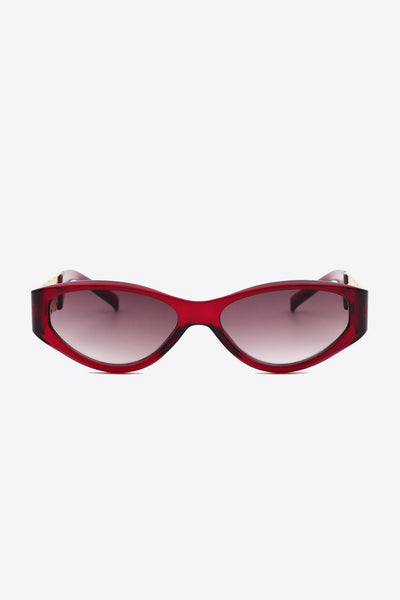 Red cat eye sunglasses with chain detail on the temples.