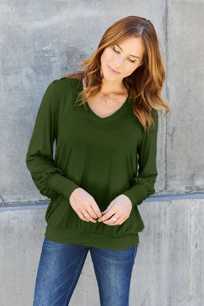 Women's olive green V-neck long sleeve top with lantern sleeves.