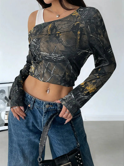 Asymmetrical long sleeve top with a camouflage print and cutout detail.