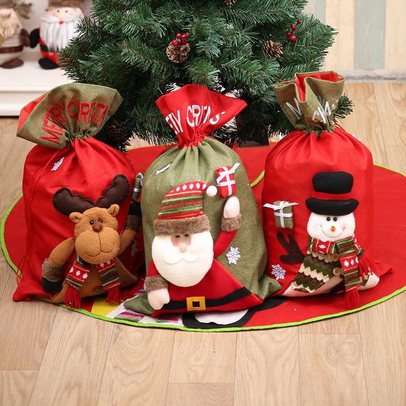 Three Christmas drawstring gift bags featuring a reindeer, Santa, and snowman.